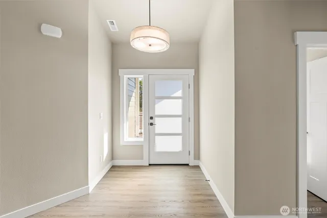 a view of a hallway with wooden floor