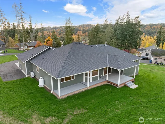 a aerial view of a house with a yard pool and sitting area