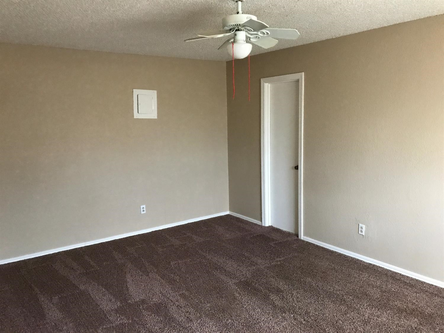 1608 59th Street, Unit 3 Lubbock, TX 79412 - Photo 4 of 8 a view of an empty room with a chandelier fan