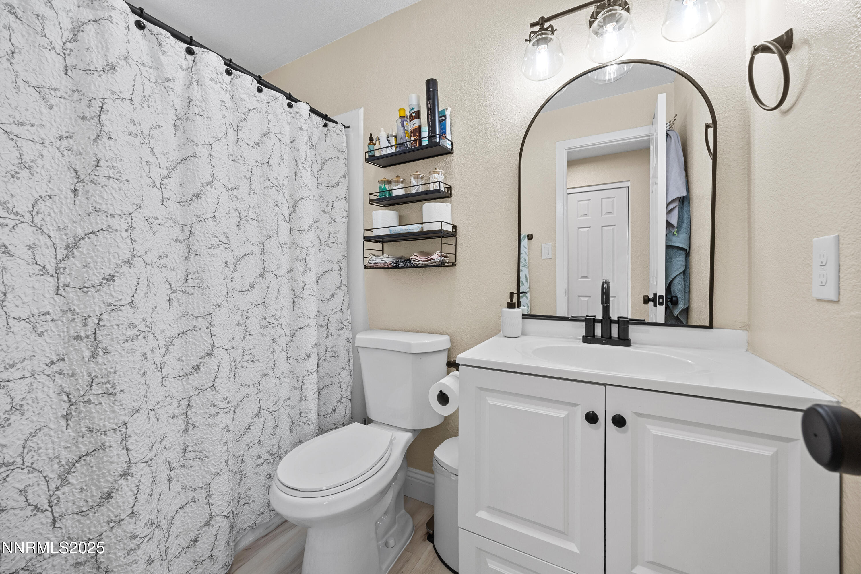 2138 Rizzo Drive Sparks, NV 89434 - Photo 19 of 24 a bathroom with a granite countertop toilet sink and mirror