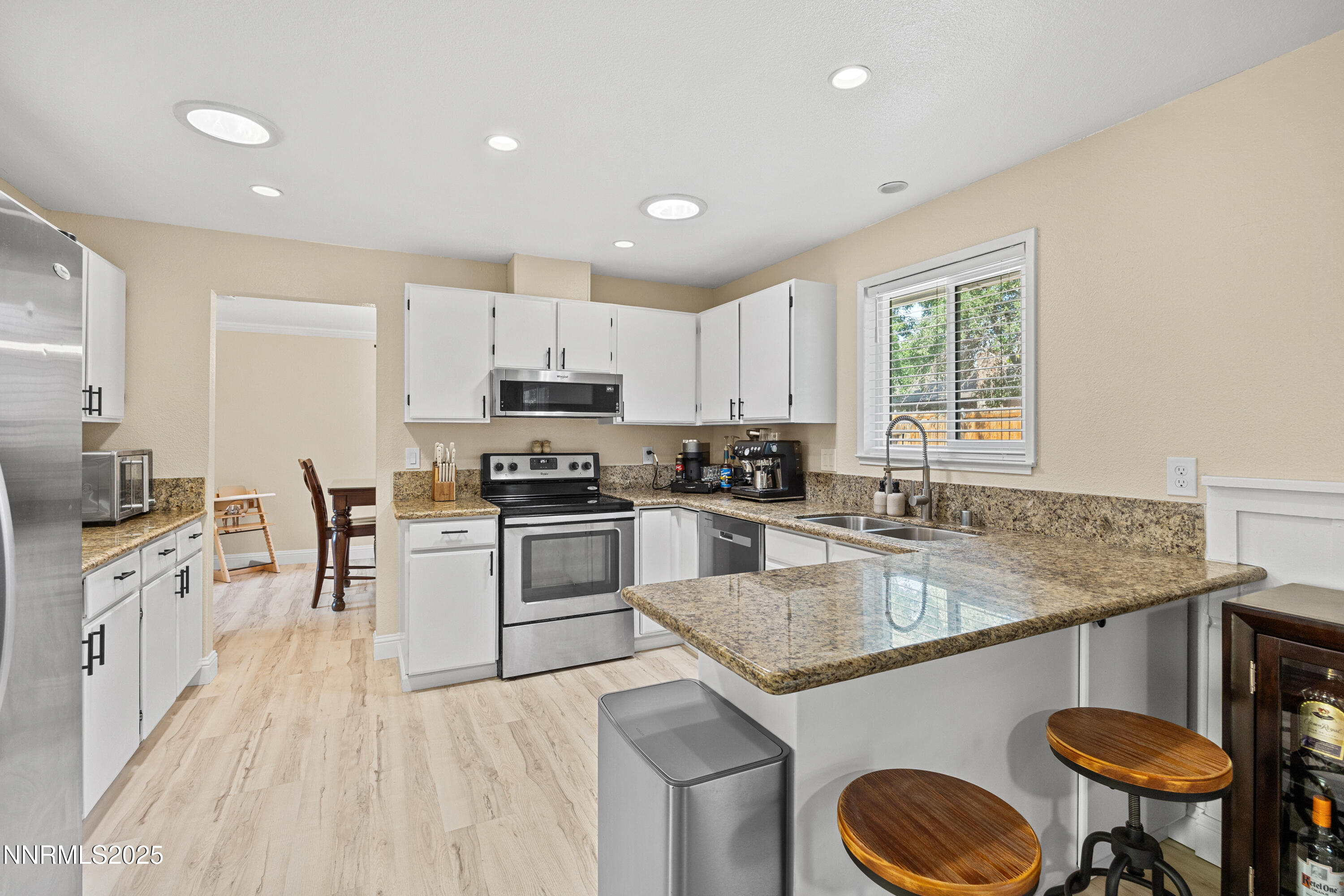 2138 Rizzo Drive Sparks, NV 89434 - Photo 8 of 24 a kitchen with granite countertop stainless steel appliances a sink a stove a counter space and a window
