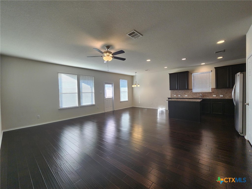 5822 Hopkins Drive Temple, TX 76502 - Photo 12 of 32 an empty room with wooden floor and windows