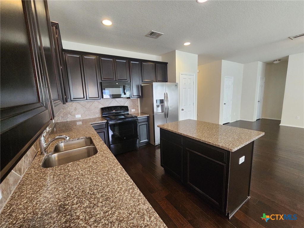 5822 Hopkins Drive Temple, TX 76502 - Photo 15 of 32 a kitchen with a refrigerator sink and stove