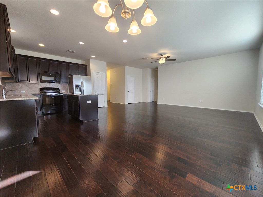 5822 Hopkins Drive Temple, TX 76502 - Photo 16 of 32 a view of a kitchen with furniture and a wooden floor