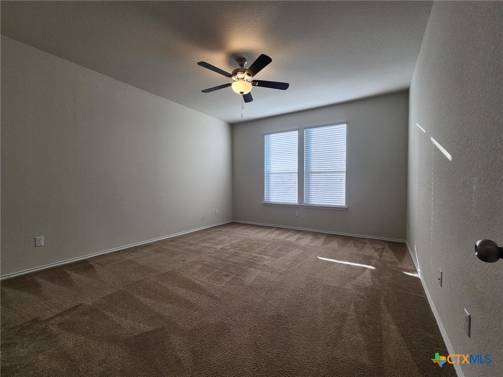 5822 Hopkins Drive Temple, TX 76502 - Photo 20 of 32 an empty room with windows and fan