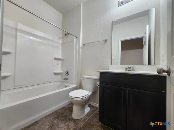 a bathroom with a toilet and a bathtub