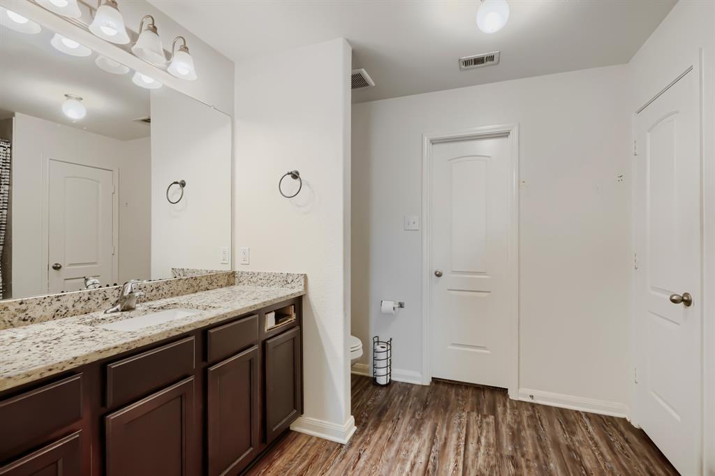 4309 Cat Tail Way Forney, TX 75126 - Photo 19 of 30 Master bathroom with dual vanity with a stone countertop and integrated sinks