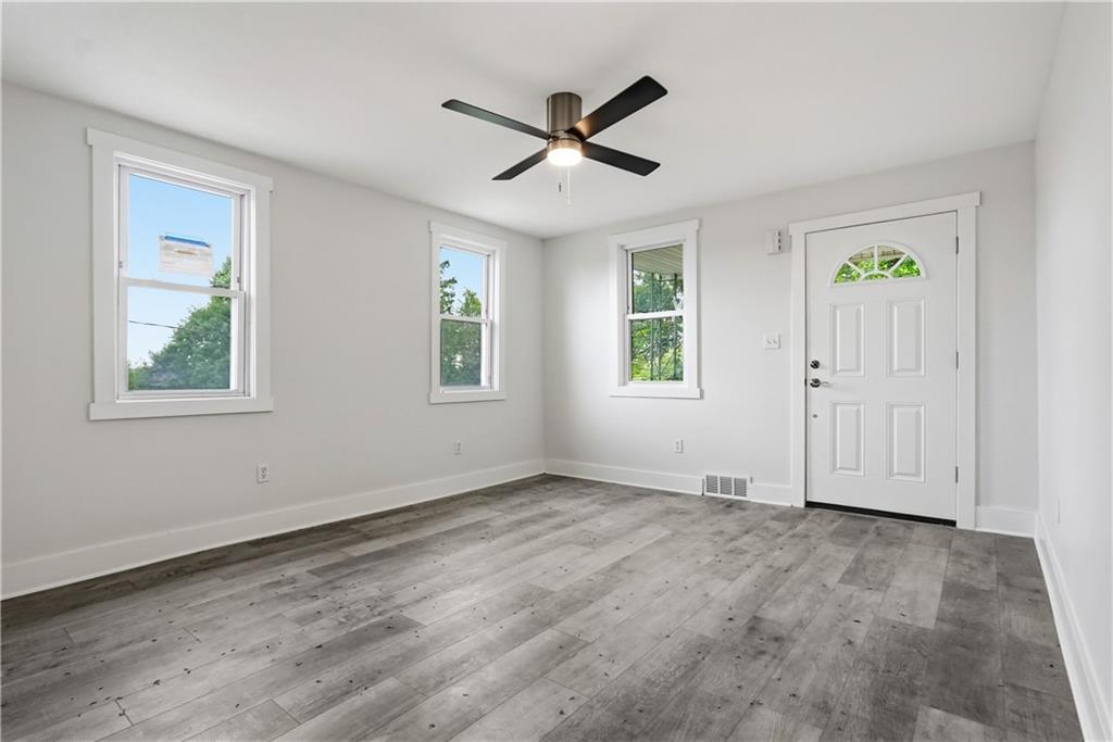 480 Songo Street Pittsburgh, PA 15227 - Photo 7 of 36 a view of empty room with wooden floor and fan