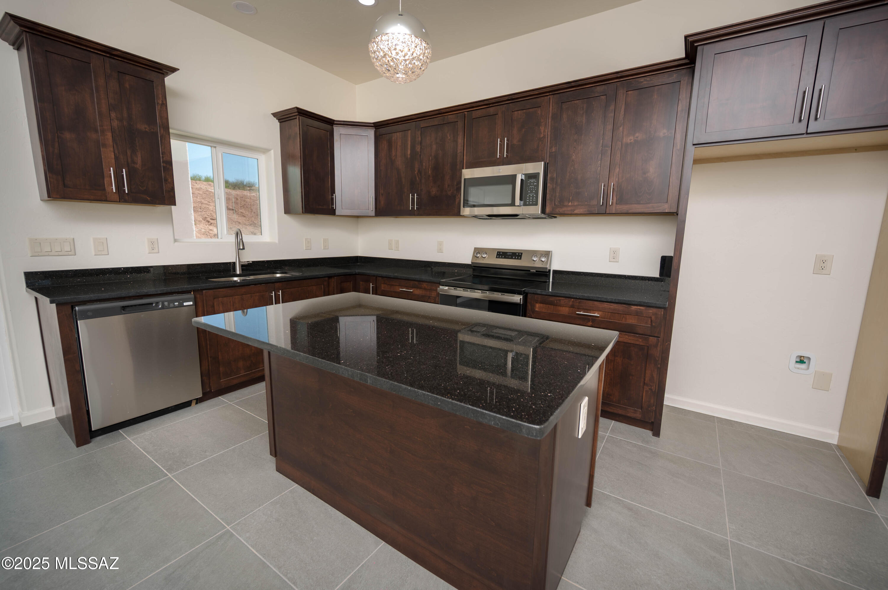 280 Donna Court Rio Rico, AZ 85648 - Photo 20 of 50 a kitchen with stainless steel appliances granite countertop a sink stove and microwave