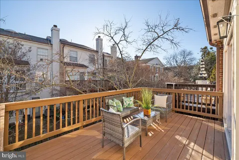 a view of a balcony with wooden floor and fence
