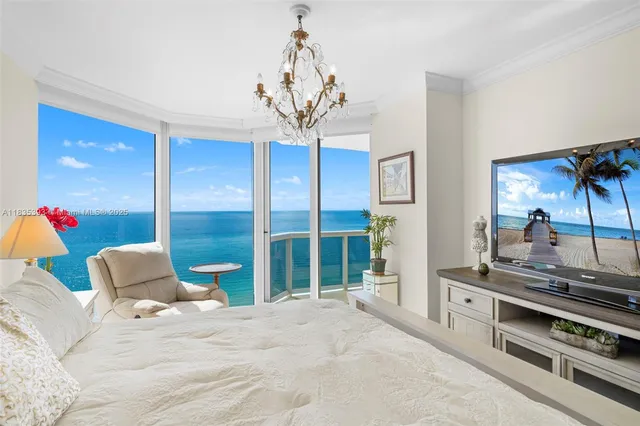 a bedroom with a bed and a flat tv screen on the dresser
