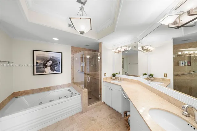 a spacious bathroom with a tub a double vanity sink a mirror and a shower