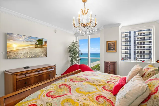 a bedroom with a bed and a flat screen tv on dresser