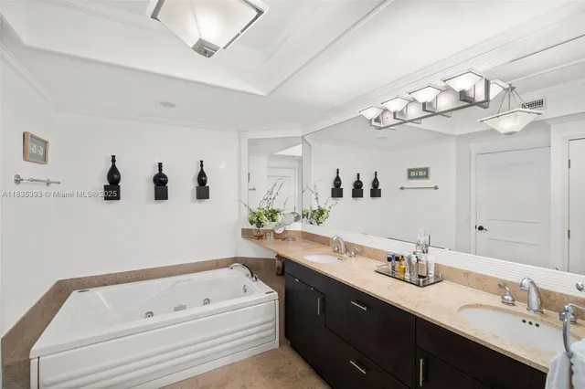 a bathroom with a sink a large mirror and vanity