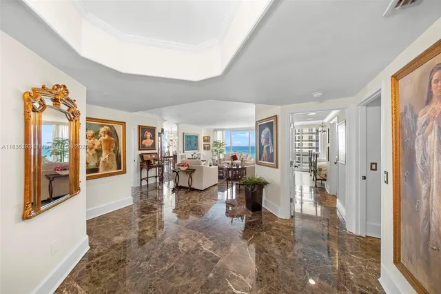 a living room with furniture large window and glass door