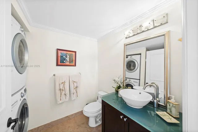 a bathroom with a granite countertop sink a mirror and a toilet