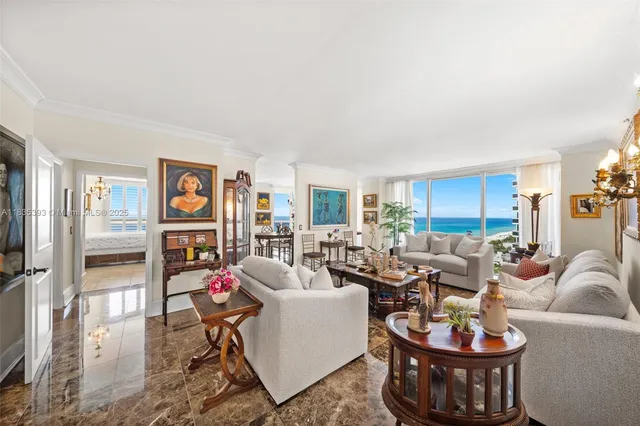 a living room with furniture a lamp and a potted plant