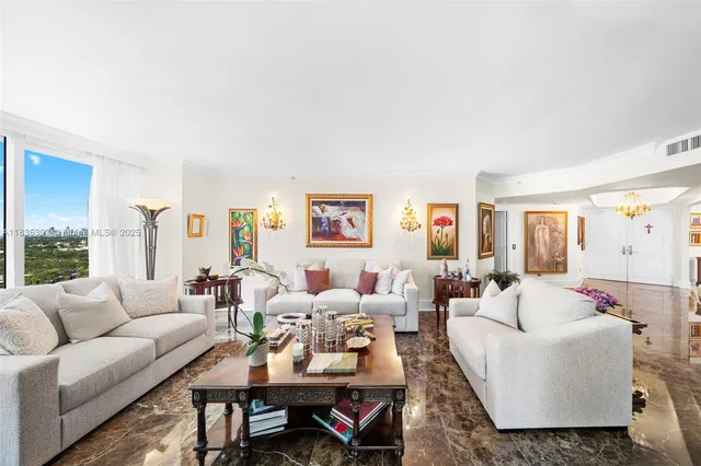 a living room with furniture kitchen view and a large window