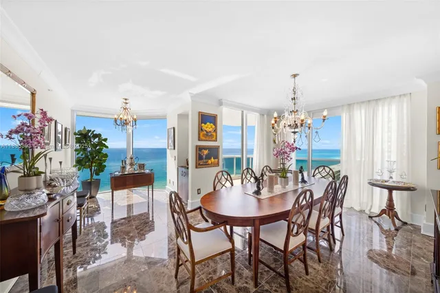 a view of a dining room with furniture and chandelier