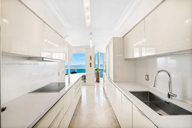 a kitchen with a sink and refrigerator