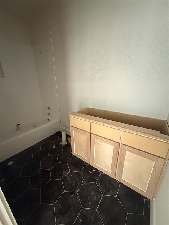 317 Jonny Boy Way Springtown, TX 76082 - Photo 21 of 34 Downstairs guest bedroom with octagon tiled floors