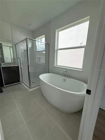 a spacious bathroom with a bathtub and a shower