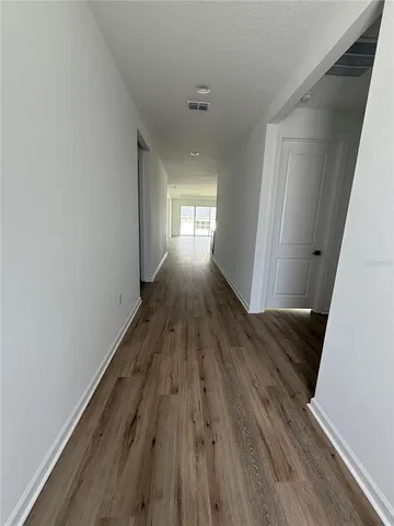 a view of gallery with wooden floor