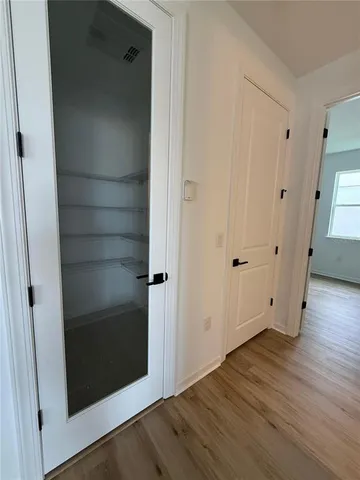 an empty room with wooden floor