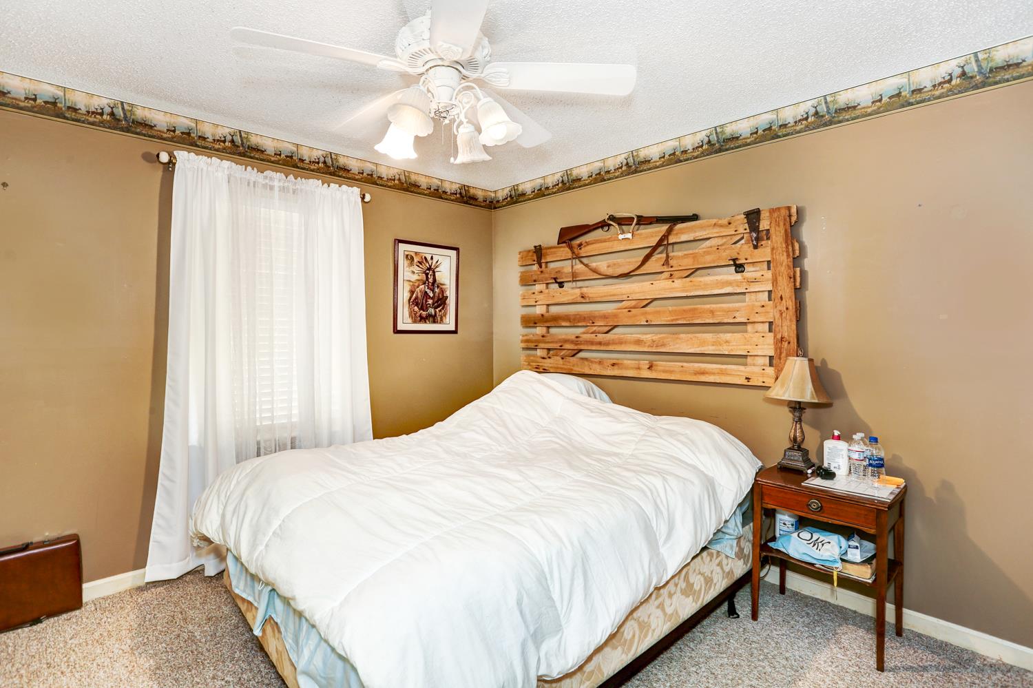 2345 Crescentview Road Pulaski, TN 38478 - Photo 13 of 23 a bedroom with a bed and a chandelier