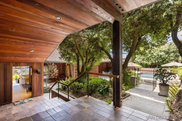 a view of a chairs and table in backyard of the house