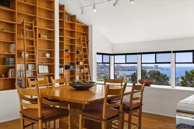 a dining room with furniture and a floor to ceiling window