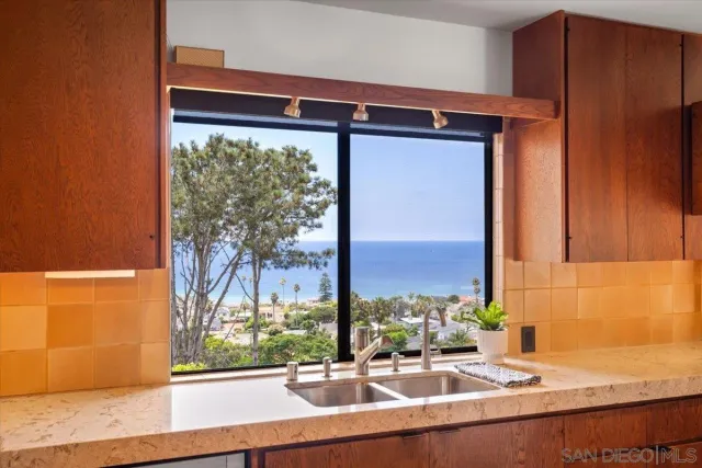 a kitchen with a sink and a large window