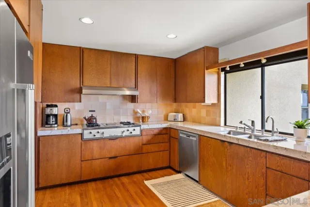 a kitchen with a sink stove and cabinets