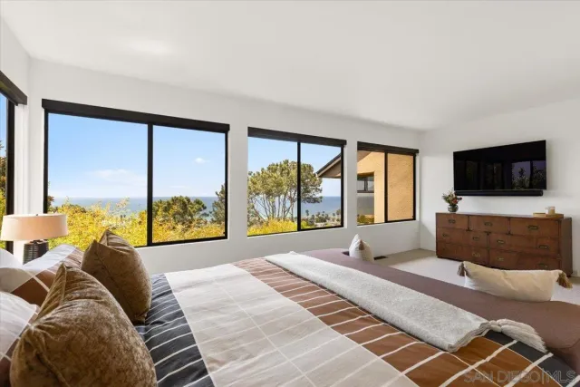 a bedroom with a large bed and a large window