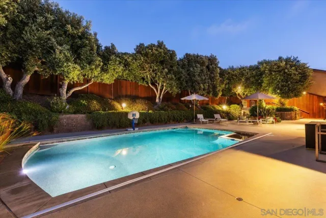 a aerial view of a house with a yard table and chairs