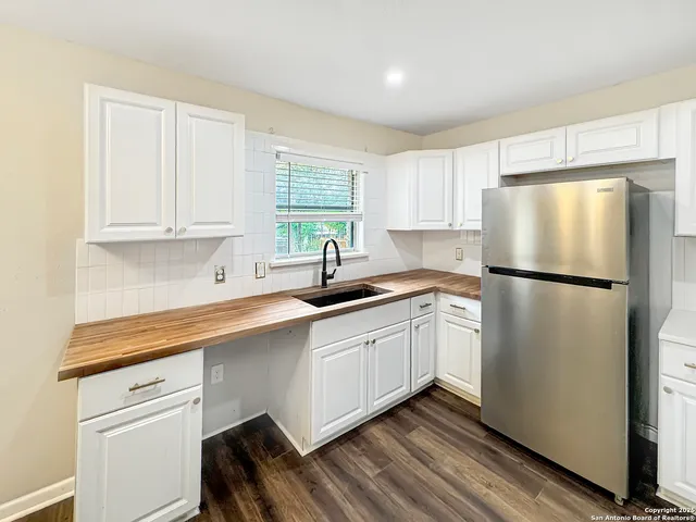 a kitchen with a stove a refrigerator and a fireplace