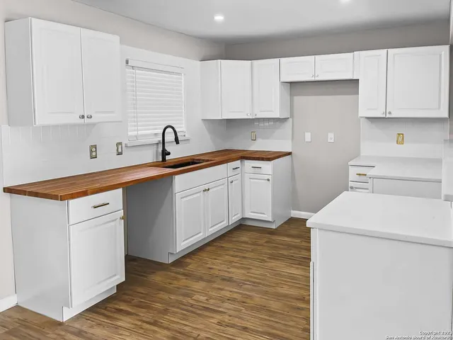 a kitchen with a sink cabinets and appliances