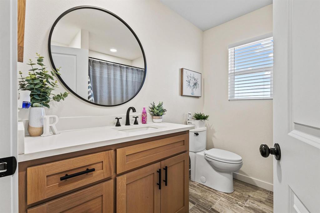 997 Private Road Brookston, TX 24977 - Photo 24 of 28 a bathroom with a sink a mirror and a toilet