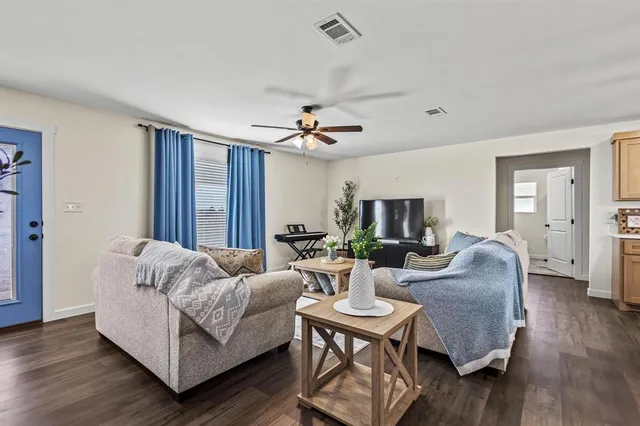 a living room with furniture and wooden floor