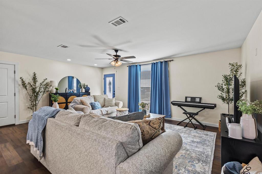 997 Private Road Brookston, TX 24977 - Photo 5 of 28 a living room with furniture a dining table and chairs with wooden floor