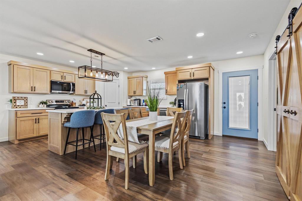 997 Private Road Brookston, TX 24977 - Photo 8 of 28 a kitchen with stainless steel appliances kitchen island granite countertop a table chairs and a refrigerator