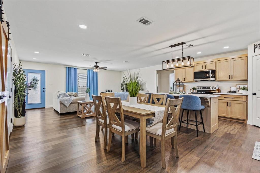 997 Private Road Brookston, TX 24977 - Photo 9 of 28 a kitchen with stainless steel appliances a table chairs refrigerator and cabinets