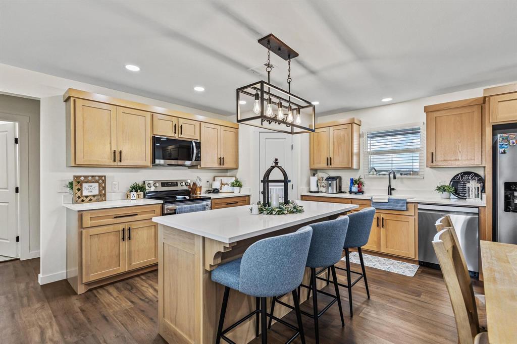 997 Private Road Brookston, TX 24977 - Photo 10 of 28 a kitchen with stainless steel appliances granite countertop a white stove top oven a sink dishwasher a dining table and chairs with wooden floor