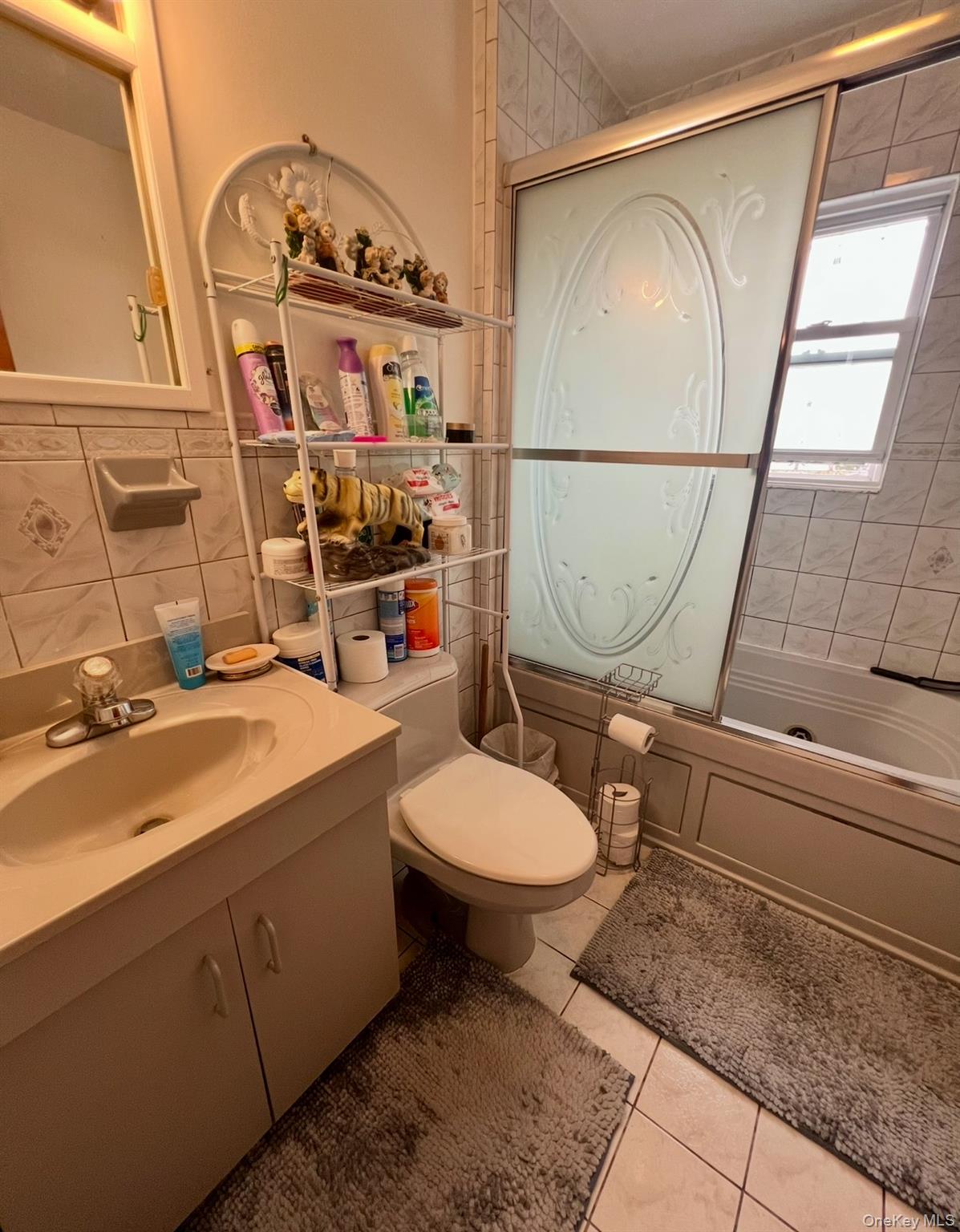 93-53 207th Street Queens, NY 11428 - Photo 19 of 36 a bathroom with a sink mirror vanity and toilet