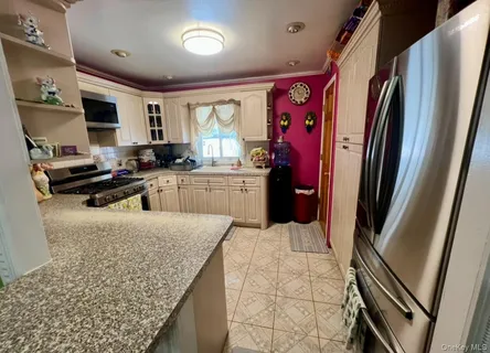 a kitchen with stainless steel appliances granite countertop a refrigerator stove and sink