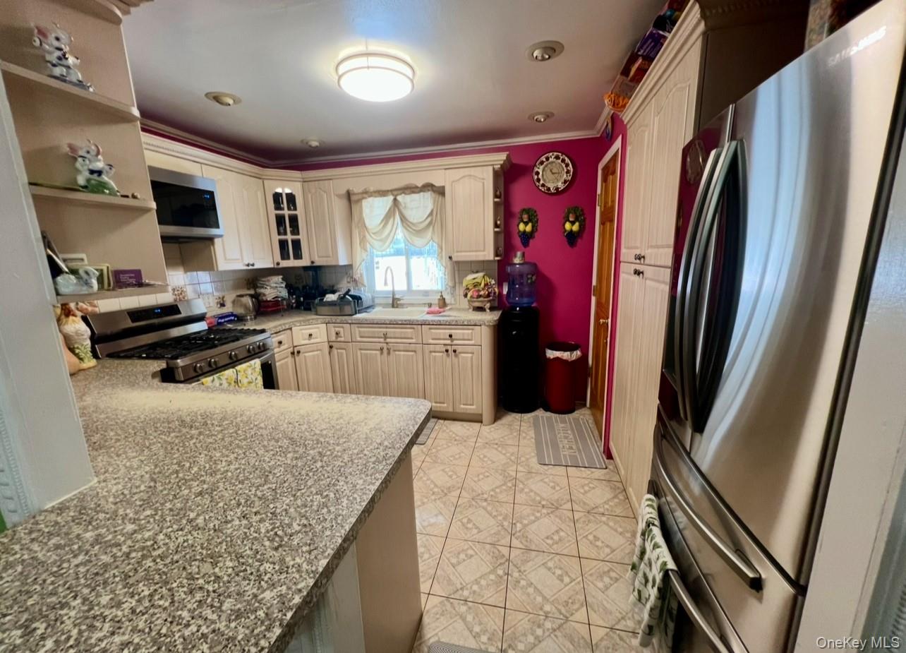 93-53 207th Street Queens, NY 11428 - Photo 21 of 36 a kitchen with stainless steel appliances granite countertop a refrigerator stove and sink
