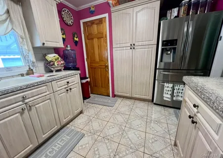 a kitchen with stainless steel appliances granite countertop a refrigerator and a stove