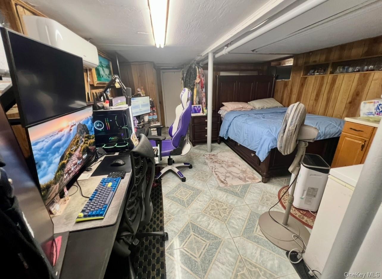 93-53 207th Street Queens, NY 11428 - Photo 26 of 36 a view of a room with furniture and a flat screen tv