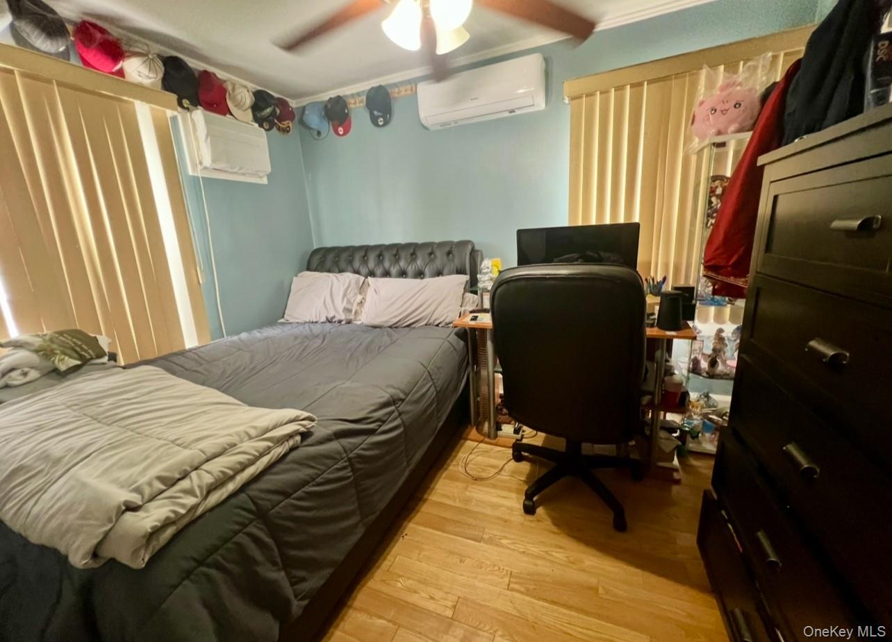 93-53 207th Street Queens, NY 11428 - Photo 30 of 36 a bedroom with a bed and a window