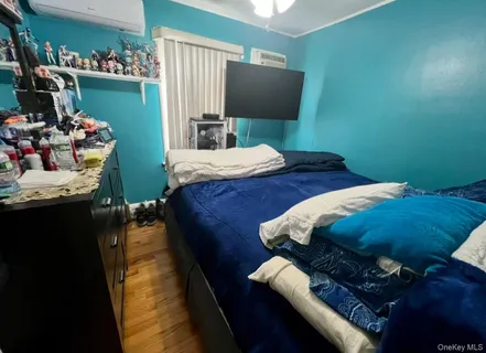 a bedroom with a bed and a television